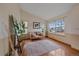 Bright living room with hardwood floors, large windows, and stylish furnishings at 13472 Monroe St, Thornton, CO 80241