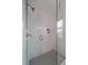Elegant bathroom shower with tiled walls, a glass door, and a sleek showerhead and fixtures at 13472 Monroe St, Thornton, CO 80241