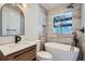 Modern bathroom featuring a soaking tub, updated vanity, and sleek tile work at 851 S Umatilla Way, Denver, CO 80223