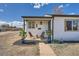 Charming covered porch with seating and decorative potted plants at 851 S Umatilla Way, Denver, CO 80223