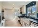 Stylish kitchen with white cabinets, subway tile, and natural light at 851 S Umatilla Way, Denver, CO 80223