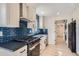 Kitchen featuring updated appliances and dark countertop and sink at 851 S Umatilla Way, Denver, CO 80223