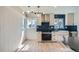 Modern kitchen with stylish lighting, new appliances, and backsplash at 851 S Umatilla Way, Denver, CO 80223