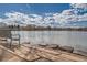 Scenic view of a calm lake from a stone path with a park bench at 851 S Umatilla Way, Denver, CO 80223