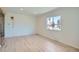 Bright living room with light hardwood floors and a large window providing ample natural light at 851 S Umatilla Way, Denver, CO 80223