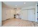 Bright living room featuring sleek light hardwood floors, white walls, and a convenient sink area at 851 S Umatilla Way, Denver, CO 80223