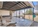 Outdoor patio with a metal roof structure, concrete flooring, and view of yard at 851 S Umatilla Way, Denver, CO 80223