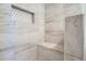 Shower with updated tile work, bench, and storage cubby at 851 S Umatilla Way, Denver, CO 80223