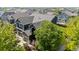 Aerial view showcasing the property's three-car garage, American flag, and mature landscaping at 11545 E 119Th Ave, Commerce City, CO 80640