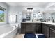 Bathroom featuring a soaking tub, large vanity with dual sinks, and a separate shower at 11545 E 119Th Ave, Commerce City, CO 80640