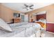Bright bedroom with natural light and a large bed with a wooden frame and a view to the mirror at 11545 E 119Th Ave, Commerce City, CO 80640