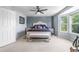 Spacious bedroom featuring a ceiling fan, large window, and a comfortable seating area at 11545 E 119Th Ave, Commerce City, CO 80640