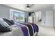 Bright bedroom with a large bay window, ceiling fan, walk-in closet, and ensuite bath access at 11545 E 119Th Ave, Commerce City, CO 80640