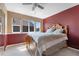 Comfortable bedroom with natural light and a large bed with a wooden frame at 11545 E 119Th Ave, Commerce City, CO 80640