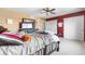 Bedroom boasting a dresser with a TV, closet, and light ceiling fan at 11545 E 119Th Ave, Commerce City, CO 80640