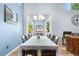 Elegant dining room with a large bay window, chandelier, and hardwood flooring at 11545 E 119Th Ave, Commerce City, CO 80640