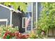 Charming home featuring an American flag, flower beds and attractive landscaping at 11545 E 119Th Ave, Commerce City, CO 80640