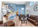 Spacious living room featuring soaring ceilings, hardwood floors, and comfortable leather seating at 11545 E 119Th Ave, Commerce City, CO 80640