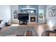 Bright living room with a cozy fireplace and natural light at 11545 E 119Th Ave, Commerce City, CO 80640
