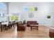 Bright open-concept living room and dining area with large windows and hardwood floors at 11545 E 119Th Ave, Commerce City, CO 80640