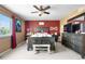 Spacious main bedroom featuring a window with curtains, and dresser with mounted TV at 11545 E 119Th Ave, Commerce City, CO 80640