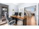 Well-appointed office space with a large desk and a view of the staircase and foyer at 11545 E 119Th Ave, Commerce City, CO 80640