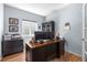 Cozy home office with a spacious desk, built-in storage, and natural light at 11545 E 119Th Ave, Commerce City, CO 80640