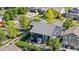 Beautifully landscaped backyard featuring patio, green grass, mature trees, and exterior of home at 11545 E 119Th Ave, Commerce City, CO 80640