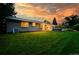 Backyard view at sunset with lush lawn at 2775 E Dartmouth Ave, Denver, CO 80210