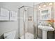 Updated bathroom with a walk-in shower and pedestal sink at 2775 E Dartmouth Ave, Denver, CO 80210