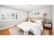 Spacious bedroom with large windows and beige upholstered headboard at 2775 E Dartmouth Ave, Denver, CO 80210