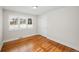 Well-lit bedroom featuring hardwood floors and shutters at 2775 E Dartmouth Ave, Denver, CO 80210