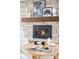 Modern gas fireplace with a wood mantel and brick surround at 2775 E Dartmouth Ave, Denver, CO 80210