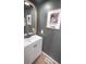 Modern bathroom with white vanity and dark gray walls at 2245 E 103Rd Pl, Thornton, CO 80229