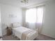 Serene bedroom featuring a white metal bed frame and neutral decor at 2245 E 103Rd Pl, Thornton, CO 80229