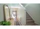 Bright entryway with mirror, console table, and carpeted stairs at 2245 E 103Rd Pl, Thornton, CO 80229