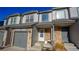 Townhouse exterior showcases gray siding, stone accents, and landscaping at 2245 E 103Rd Pl, Thornton, CO 80229