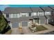 Townhome exterior with gray siding and a two-car garage at 2245 E 103Rd Pl, Thornton, CO 80229