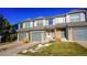 Townhouse exterior features gray siding, stone accents, and landscaping at 2245 E 103Rd Pl, Thornton, CO 80229