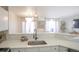 Clean kitchen boasts a farmhouse sink and sleek black faucet at 2245 E 103Rd Pl, Thornton, CO 80229