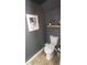 Chic powder room with dark gray walls, wood shelf, and modern toilet at 2245 E 103Rd Pl, Thornton, CO 80229