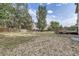 Gravel area in the backyard leads to wooden fence with mature trees at 10288 Salida St, Commerce City, CO 80022