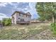 View of the home and its deck from the large backyard at 10288 Salida St, Commerce City, CO 80022