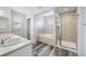 Bathroom featuring a separate shower and soaking tub, tile surround, and vinyl flooring at 10288 Salida St, Commerce City, CO 80022