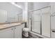 Clean bathroom with glass enclosed shower, white cabinets, and updated sink at 10288 Salida St, Commerce City, CO 80022