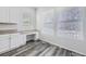 White kitchen with granite countertops and built-in desk area at 10288 Salida St, Commerce City, CO 80022