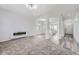 Spacious living room featuring plush carpet, archways, and a modern fireplace at 10288 Salida St, Commerce City, CO 80022