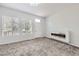 Cozy living room with plush carpeting, a modern fireplace, and bright windows at 10288 Salida St, Commerce City, CO 80022