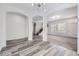 Open-concept living room with gray wood floors, arched doorways, and modern lighting at 10288 Salida St, Commerce City, CO 80022