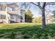 Expansive backyard with lush green grass, mature trees, and a peaceful outdoor setting at 17020 W 64Th Dr, Arvada, CO 80007